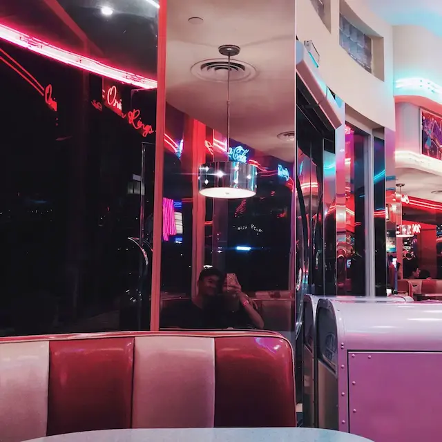 my partner and I in the mirror of a diner